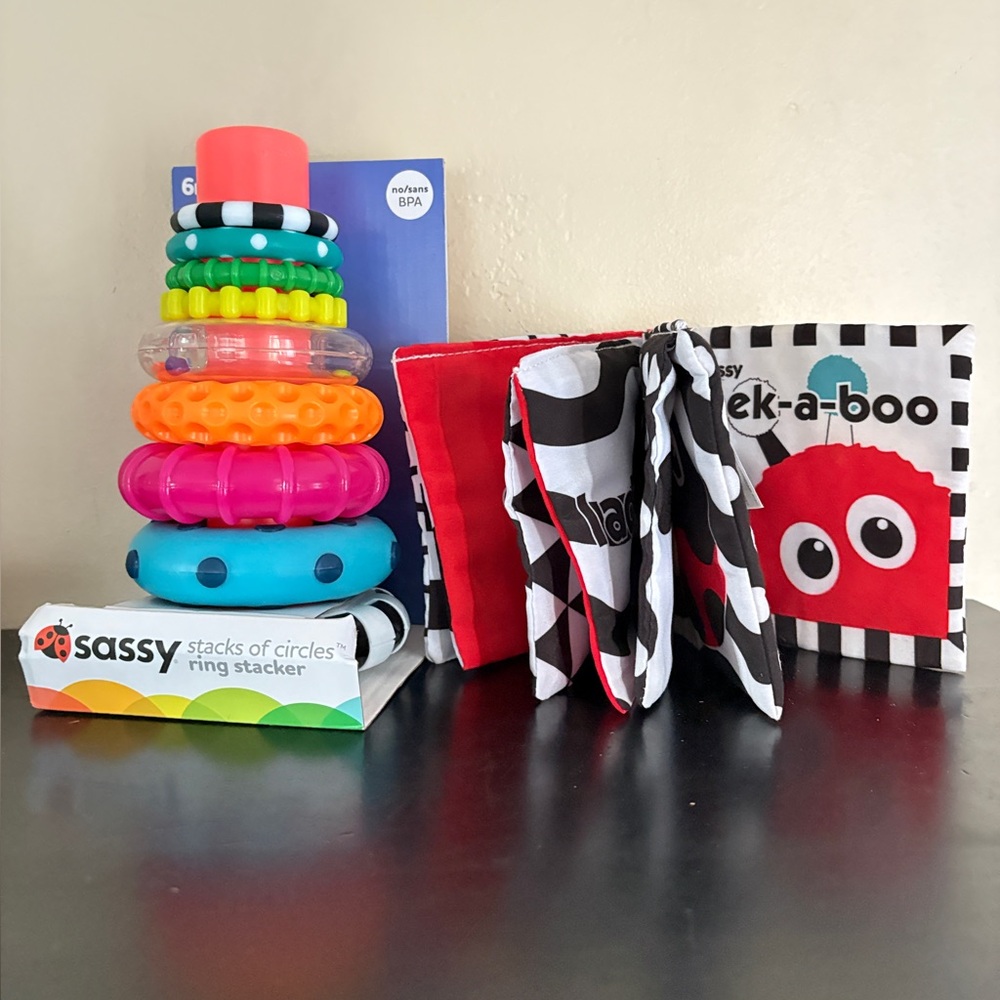 Sassy Baby, Inc. lot of 2 baby/ infant toys. Stacker, brand new; peek a boo book